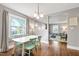 Bright dining room with a modern white table and colorful green chairs, open to the living room at 1003 E Club Blvd, Durham, NC 27704