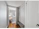 Hallway with hardwood floors, coat rack, and view into the bedroom at 1003 E Club Blvd, Durham, NC 27704