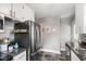 Modern kitchen features stainless steel refrigerator and appliances with white cabinetry and dark countertops at 1003 E Club Blvd, Durham, NC 27704