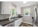 Efficient kitchen space featuring modern stainless steel appliances and neutral color palette at 1003 E Club Blvd, Durham, NC 27704