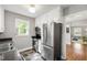 Charming kitchen with stainless steel appliances, a window view, and an open doorway to other rooms at 1003 E Club Blvd, Durham, NC 27704