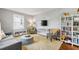 Cozy living room features comfortable seating, a soft rug, and a bright window for natural light at 1003 E Club Blvd, Durham, NC 27704