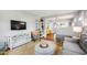 Relaxing living room features hardwood floors and gray couches, open to other rooms at 1003 E Club Blvd, Durham, NC 27704