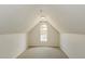 Finished attic space with a window, carpeted floors, neutral walls, and plenty of potential at 1003 Walnut Dr, Erwin, NC 28339
