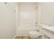 Clean bathroom featuring a tub-shower combination with white tile surround at 1003 Walnut Dr, Erwin, NC 28339