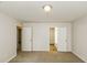 Spacious bedroom with neutral walls and carpeted floors, with an ensuite bathroom and hallway access at 1003 Walnut Dr, Erwin, NC 28339