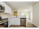 Modern kitchen with stainless steel appliances, white cabinetry, and a pass-through to the living area at 1003 Walnut Dr, Erwin, NC 28339