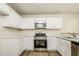Bright kitchen featuring stainless steel appliances, and ample white cabinetry with updated countertops at 1003 Walnut Dr, Erwin, NC 28339