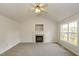 Living room with a fireplace, large window, and neutral walls perfect for entertaining at 1003 Walnut Dr, Erwin, NC 28339