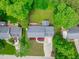 Aerial view showcases the backyard's deck, screened porch, and tree-lined perimeter at 1007 Wellstone Cir, Apex, NC 27502