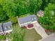 Beautiful aerial view of the home surrounded by mature trees and lush landscaping at 1007 Wellstone Cir, Apex, NC 27502