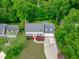 Aerial view of a traditional two-story home with a well-manicured lawn and mature landscaping at 1007 Wellstone Cir, Apex, NC 27502