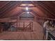 Spacious unfinished attic featuring exposed wooden beams, plywood flooring, and visible HVAC components at 1007 Wellstone Cir, Apex, NC 27502