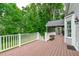 Large back deck with white railings overlooking a beautifully landscaped backyard at 1007 Wellstone Cir, Apex, NC 27502
