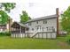 Spacious backyard featuring a deck, screened porch and lush green lawn at 1007 Wellstone Cir, Apex, NC 27502