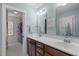 Bathroom with double sinks, a walk-in closet, and light blue walls at 1007 Wellstone Cir, Apex, NC 27502