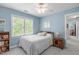 Comfortable bedroom with carpet flooring, a ceiling fan and natural light streaming in through the windows at 1007 Wellstone Cir, Apex, NC 27502