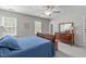 Bedroom with ceiling fan, dresser, and two windows providing natural light at 1007 Wellstone Cir, Apex, NC 27502