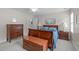 Well-lit bedroom with wood furniture and ceiling fan at 1007 Wellstone Cir, Apex, NC 27502