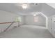 Spacious bonus room with carpet flooring, ceiling fans, and natural light at 1007 Wellstone Cir, Apex, NC 27502