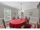 Bright dining room featuring an elegant chandelier, windows, and six-chair dining set at 1007 Wellstone Cir, Apex, NC 27502