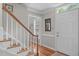 Entryway with hardwood steps and floors with a view into a brightly lit area at 1007 Wellstone Cir, Apex, NC 27502