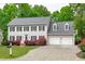 Traditional two-story home with a well-maintained lawn, charming landscaping, and a two-car garage at 1007 Wellstone Cir, Apex, NC 27502