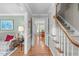 Elegant hallway with hardwood floors, staircase, and open view to the dining room at 1007 Wellstone Cir, Apex, NC 27502