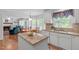 Open-concept kitchen with island, granite countertops, and view to the Gathering room at 1007 Wellstone Cir, Apex, NC 27502