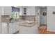 Bright kitchen with granite countertops, white cabinets and island at 1007 Wellstone Cir, Apex, NC 27502