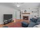Comfortable living room featuring a fireplace with wood mantel and stylish decor at 1007 Wellstone Cir, Apex, NC 27502