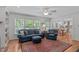 Spacious living room with comfortable seating and bright natural light from several windows at 1007 Wellstone Cir, Apex, NC 27502