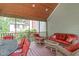 Relaxing screened in patio with wood features and plenty of comfortable seating at 1007 Wellstone Cir, Apex, NC 27502
