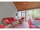 Relaxing screened porch with comfortable wicker furniture and outdoor dining area at 1007 Wellstone Cir, Apex, NC 27502