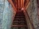 Stairs leading up to the unfinished attic of the home, surrounded by exposed insulation at 1007 Wellstone Cir, Apex, NC 27502