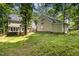 The large grassy backyard features mature trees and a wooden fence at 103 Donna Pl, Cary, NC 27513