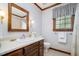 Traditional bathroom with a dark wood vanity, wall sconces, and floral wallpaper border at 103 Donna Pl, Cary, NC 27513