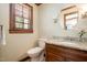 Bathroom featuring granite countertop, wooden cabinet and decorative mirror at 103 Donna Pl, Cary, NC 27513