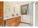 Bathroom with a double sink vanity, shower with glass door and window at 103 Donna Pl, Cary, NC 27513