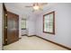 Neutral bedroom features plush carpet, a ceiling fan, and wood trim windows at 103 Donna Pl, Cary, NC 27513