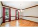Dining room featuring hardwood floors, windows, and a chandelier at 103 Donna Pl, Cary, NC 27513
