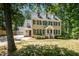 Charming two-story home with black shutters and light-colored siding surrounded by mature trees at 103 Donna Pl, Cary, NC 27513