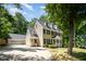Lovely two-story home with attached two car garage and a sprawling driveway surrounded by mature trees at 103 Donna Pl, Cary, NC 27513