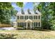Charming two-story home with dormer windows, blue shutters, complemented by a lush, landscaped front yard at 103 Donna Pl, Cary, NC 27513
