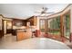 Eat-in kitchen featuring tile floors, wooden cabinetry, stainless appliances, and a sunny breakfast nook at 103 Donna Pl, Cary, NC 27513