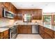 Modern kitchen with stainless steel appliances, granite countertops, and custom wood cabinetry at 103 Donna Pl, Cary, NC 27513