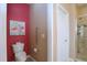 Small, bright bathroom features tiled shower, updated fixtures, grab bar, and flamingo art at 1033 Cuthbert Ln, Durham, NC 27703