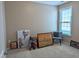 Bedroom featuring a window and decoratively adorned with paintings and a chest at 1033 Cuthbert Ln, Durham, NC 27703