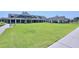 The clubhouse lawn offers a verdant vista and space for outdoor activities at 1033 Cuthbert Ln, Durham, NC 27703