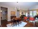 Dining room featuring a modern light fixture, hardwood floors, and transitional furnishings at 1033 Cuthbert Ln, Durham, NC 27703